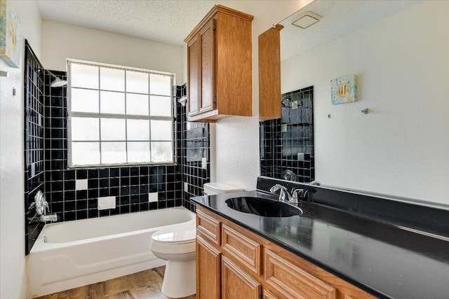1905 Hollow Tree Blvd, Round Rock, TX 78681 - full bathroom featuring vanity, wood finished floors, shower / bathtub combination, and a textured ceiling