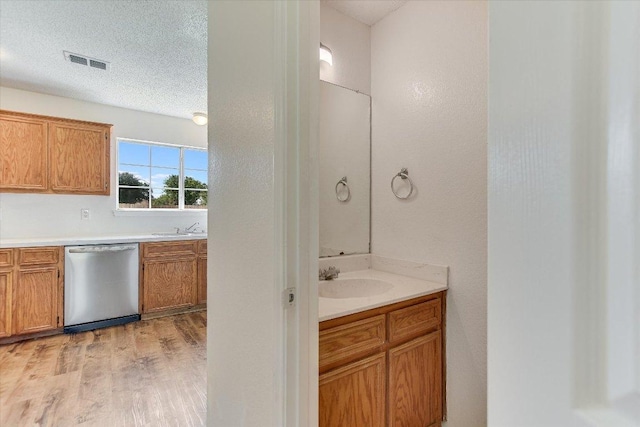 1905 Hollow Tree Blvd, Round Rock, TX 78681 - bathroom with wood finished floors, vanity, and a textured ceiling