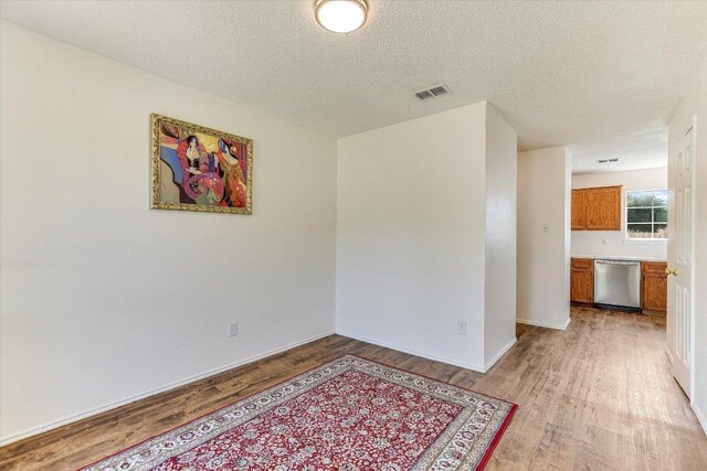 1905 Hollow Tree Blvd, Round Rock, TX 78681 - unfurnished room with light wood finished floors and a textured ceiling