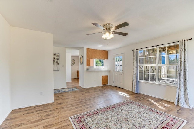 1905 Hollow Tree Blvd, Round Rock, TX 78681 - unfurnished living room featuring wood finished floors, ceiling fan, and baseboards