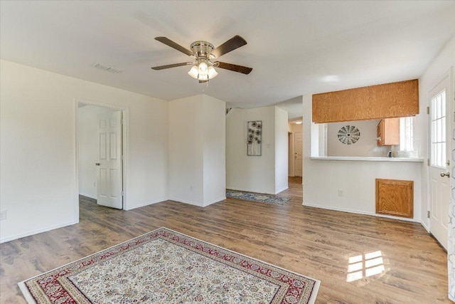1905 Hollow Tree Blvd, Round Rock, TX 78681 - unfurnished living room featuring a ceiling fan, wood finished floors, and baseboards