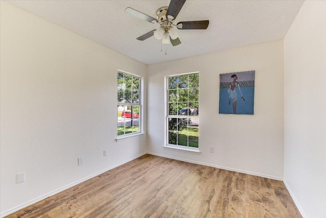 1905 Hollow Tree Blvd, Round Rock, TX 78681 - spare room featuring wood finished floors, ceiling fan, baseboards, and a textured ceiling