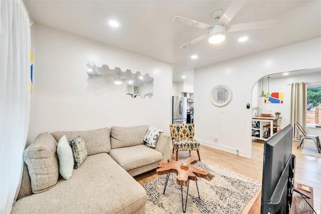 1901 E 10th St, Austin, TX 78702 - living area with light wood finished floors, arched walkways, ceiling fan, recessed lighting, and baseboards