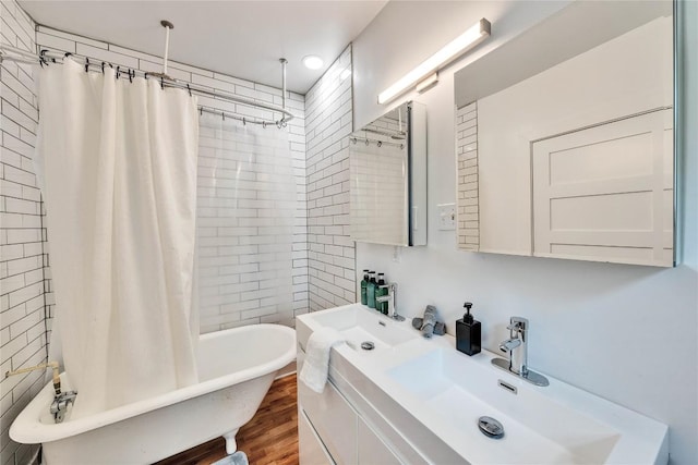 1901 E 10th St, Austin, TX 78702 - full bathroom with vanity, wood finished floors, and shower / bath combo