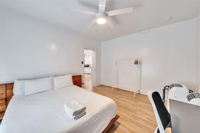 1901 E 10th St, Austin, TX 78702 - bedroom featuring light wood-style flooring, ceiling fan, and baseboards