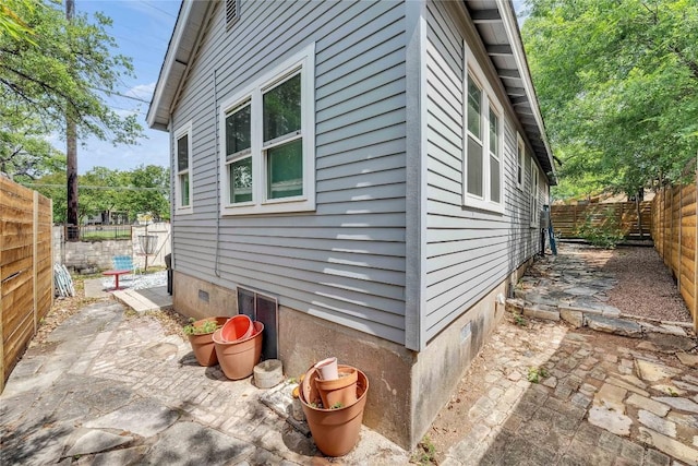 1901 E 10th St, Austin, TX 78702 - view of side of property with a fenced backyard, a patio, and crawl space