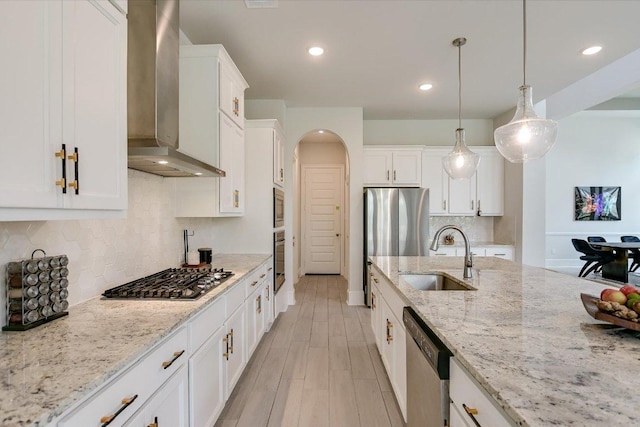 604 Rawson Bnd, Austin, TX 78738 - kitchen with wall chimney exhaust hood, stainless steel appliances, white cabinets, hanging light fixtures, and recessed lighting