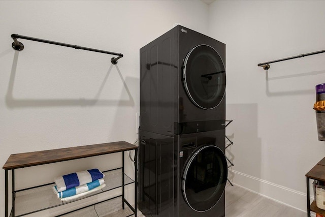 604 Rawson Bnd, Austin, TX 78738 - washroom with stacked washer / dryer and wood finished floors