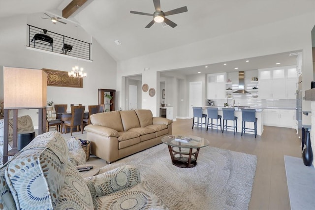 living room with ceiling fan, high vaulted ceiling, beamed ceiling, wood finished floors, and a chandelier