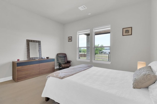 bedroom with baseboards and light wood-style floors