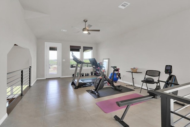 workout room with a ceiling fan, baseboards, and tile patterned flooring
