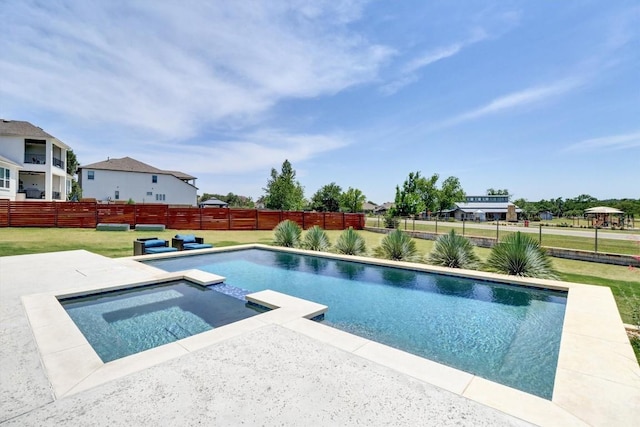 view of swimming pool with a pool with connected hot tub