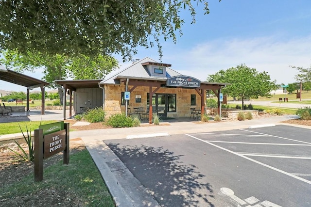 view of building exterior with uncovered parking