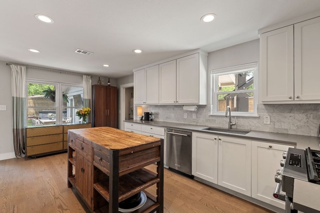 4107 Circletree Loop, Austin, TX 78731 - kitchen featuring appliances with stainless steel finishes, recessed lighting, decorative backsplash, dark countertops, and light wood-style flooring