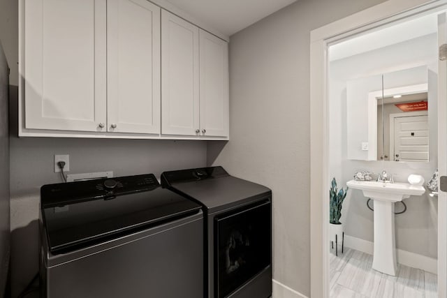 4107 Circletree Loop, Austin, TX 78731 - washroom with washing machine and dryer and cabinet space