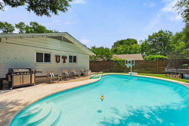 4107 Circletree Loop, Austin, TX 78731 - view of swimming pool featuring a trampoline, a fenced backyard, and a patio