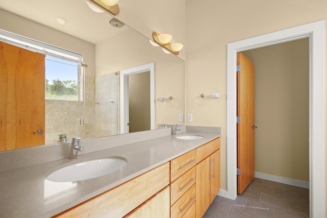 5309 Sendero Hills Pkwy, Austin, TX 78724 - full bathroom with double vanity, tiled shower, tile patterned floors, and baseboards
