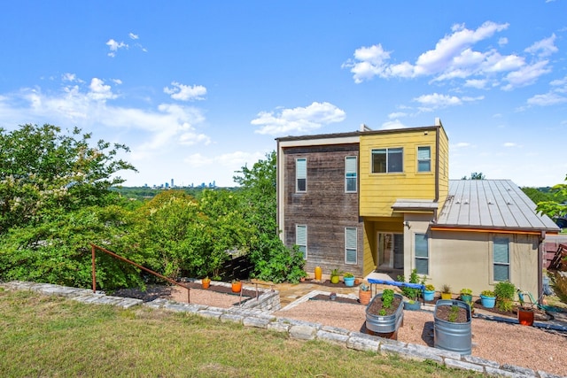 5309 Sendero Hills Pkwy, Austin, TX 78724 - view of front facade featuring a vegetable garden, a standing seam roof, and metal roof