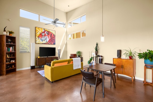 5309 Sendero Hills Pkwy, Austin, TX 78724 - living room with finished concrete flooring, baseboards, a towering ceiling, and a ceiling fan