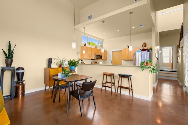 5309 Sendero Hills Pkwy, Austin, TX 78724 - dining area with a towering ceiling, concrete flooring, and recessed lighting