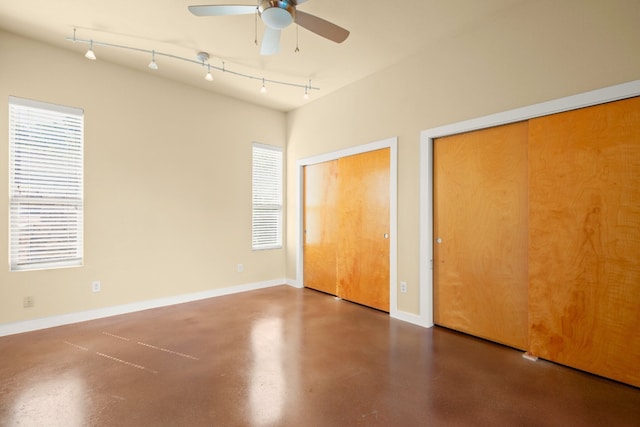 5309 Sendero Hills Pkwy, Austin, TX 78724 - unfurnished bedroom with two closets, finished concrete floors, baseboards, and a ceiling fan