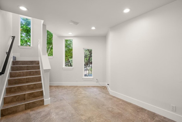 3401 Day Star Cv, Austin, TX 78746 - empty room featuring healthy amount of natural light, stairs, baseboards, and recessed lighting
