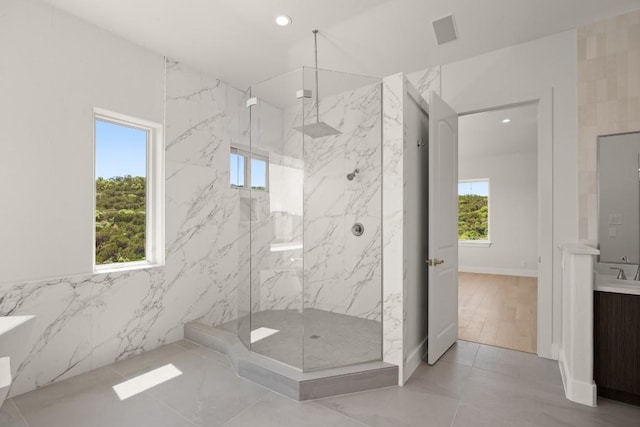 3401 Day Star Cv, Austin, TX 78746 - bathroom featuring plenty of natural light, a marble finish shower, vanity, and recessed lighting