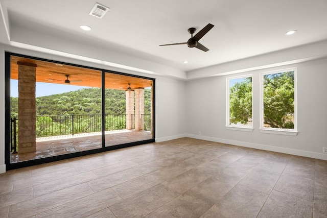3401 Day Star Cv, Austin, TX 78746 - unfurnished room with a ceiling fan, a tray ceiling, and recessed lighting