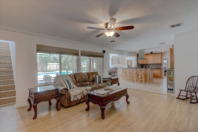 6022 Abilene Trl, Austin, TX 78749 - living area with a ceiling fan, light wood-type flooring, and crown molding