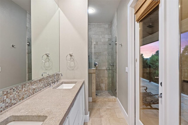 1348 Lake Shore Dr, Spicewood, TX 78669 - bathroom featuring a stall shower, double vanity, and backsplash
