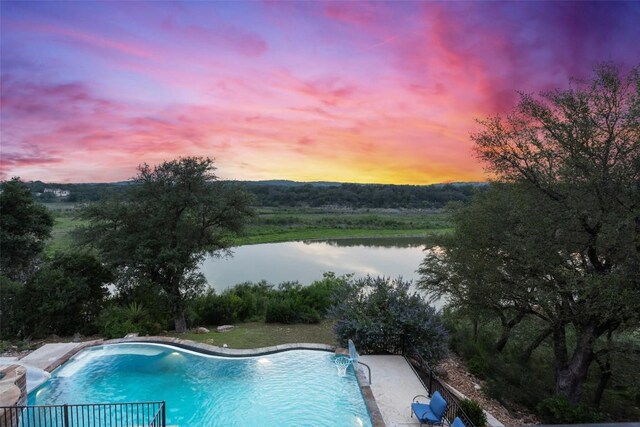1348 Lake Shore Dr, Spicewood, TX 78669 - pool at dusk with a water view and an outdoor pool