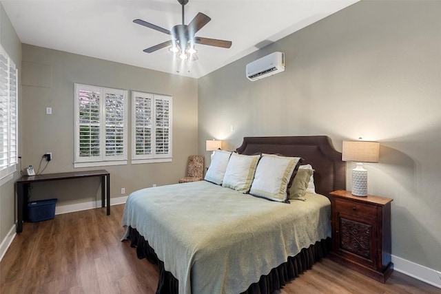 1348 Lake Shore Dr, Spicewood, TX 78669 - bedroom featuring an AC wall unit, wood finished floors, baseboards, and a ceiling fan
