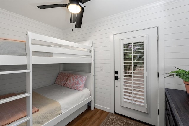 1348 Lake Shore Dr, Spicewood, TX 78669 - bedroom with wooden walls, wood finished floors, crown molding, and a ceiling fan