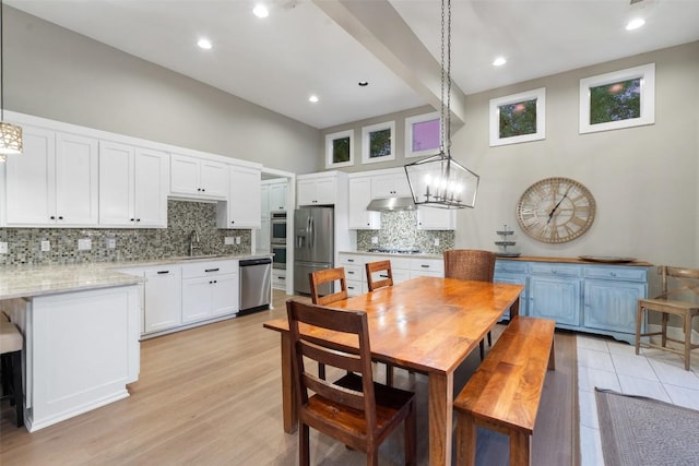 1348 Lake Shore Dr, Spicewood, TX 78669 - dining room with a chandelier, a towering ceiling, light wood-type flooring, and recessed lighting