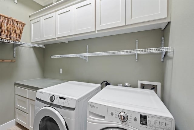 1348 Lake Shore Dr, Spicewood, TX 78669 - washroom featuring cabinet space, washing machine and dryer, and baseboards