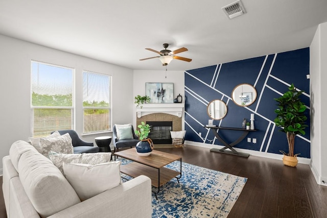 11325 Kirkland Hill Path, Austin, TX 78754 - living room featuring ceiling fan, a tiled fireplace, baseboards, and wood finished floors