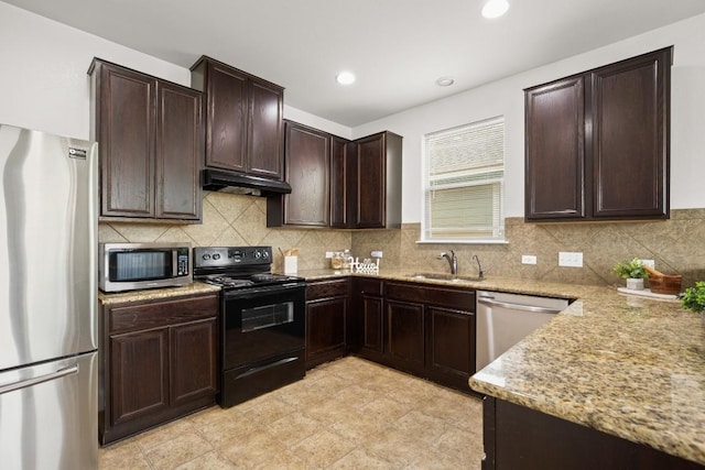 11325 Kirkland Hill Path, Austin, TX 78754 - kitchen with appliances with stainless steel finishes, under cabinet range hood, a sink, light stone countertops, and dark brown cabinetry