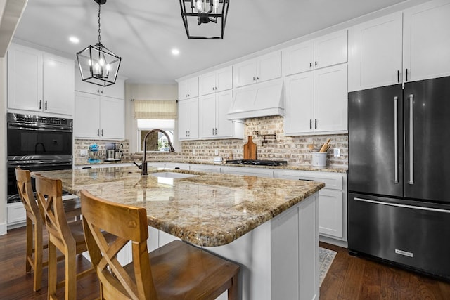 121 Gloria Blvd, Smithville, TX 78957 - kitchen with high quality fridge, a sink, custom range hood, recessed lighting, and dark wood finished floors