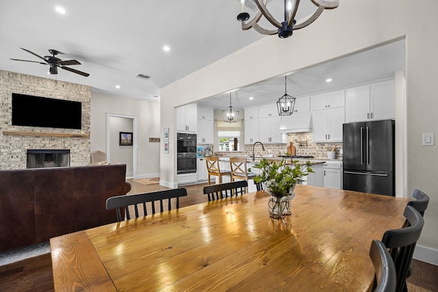 121 Gloria Blvd, Smithville, TX 78957 - dining space featuring recessed lighting, a chandelier, baseboards, a ceiling fan, and dark wood finished floors