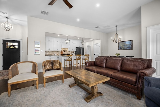 121 Gloria Blvd, Smithville, TX 78957 - living room with a chandelier, a ceiling fan, recessed lighting, and light wood finished floors