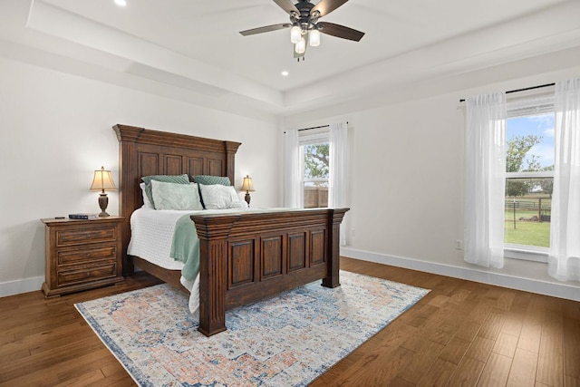 121 Gloria Blvd, Smithville, TX 78957 - bedroom featuring a raised ceiling, baseboards, dark wood-type flooring, recessed lighting, and ceiling fan