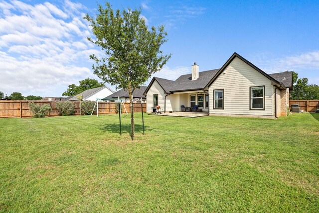 121 Gloria Blvd, Smithville, TX 78957 - back of property featuring a chimney and a patio