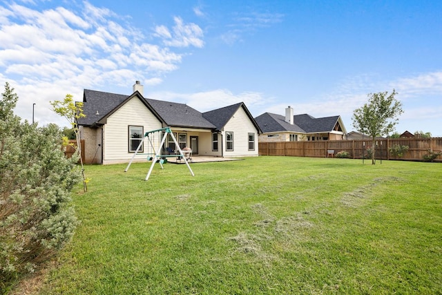 121 Gloria Blvd, Smithville, TX 78957 - back of house featuring a patio and a chimney