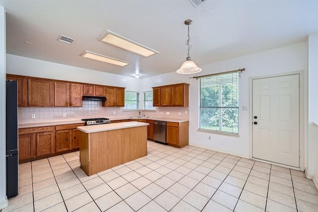 4712 Ramies Run, Austin, TX 78749 - kitchen featuring dishwasher, stove, under cabinet range hood, and backsplash