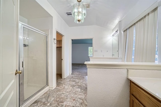 4712 Ramies Run, Austin, TX 78749 - bathroom with a stall shower, vanity, vaulted ceiling, a walk in closet, and marble finish flooring
