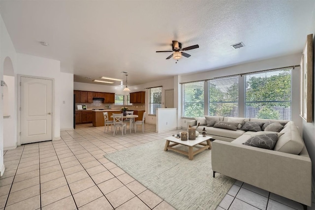 4712 Ramies Run, Austin, TX 78749 - living room featuring ceiling fan, arched walkways, and light tile patterned flooring
