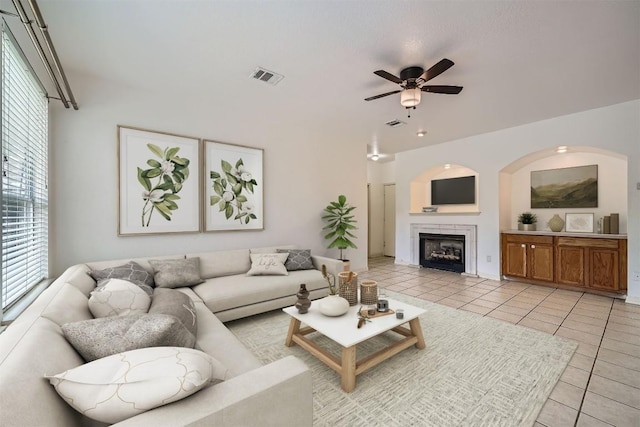 4712 Ramies Run, Austin, TX 78749 - living room with light tile patterned floors, ceiling fan, and a tile fireplace