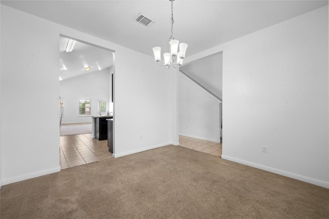 carpeted spare room featuring a chandelier, lofted ceiling, tile patterned floors, and baseboards