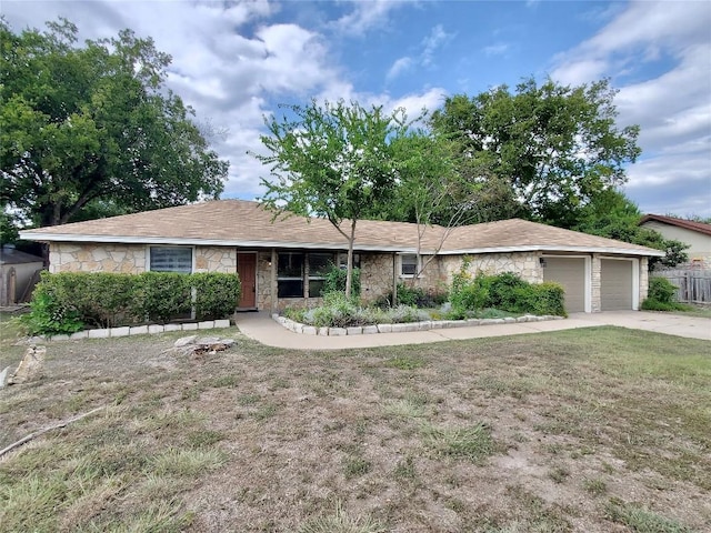 9512 Meadowheath Dr, Austin, TX 78729 - single story home with stone siding, driveway, and an attached garage