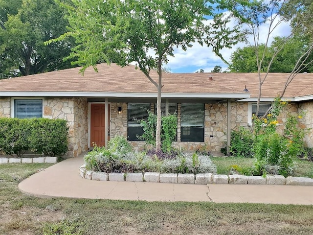 9512 Meadowheath Dr, Austin, TX 78729 - ranch-style house with stone siding and roof with shingles